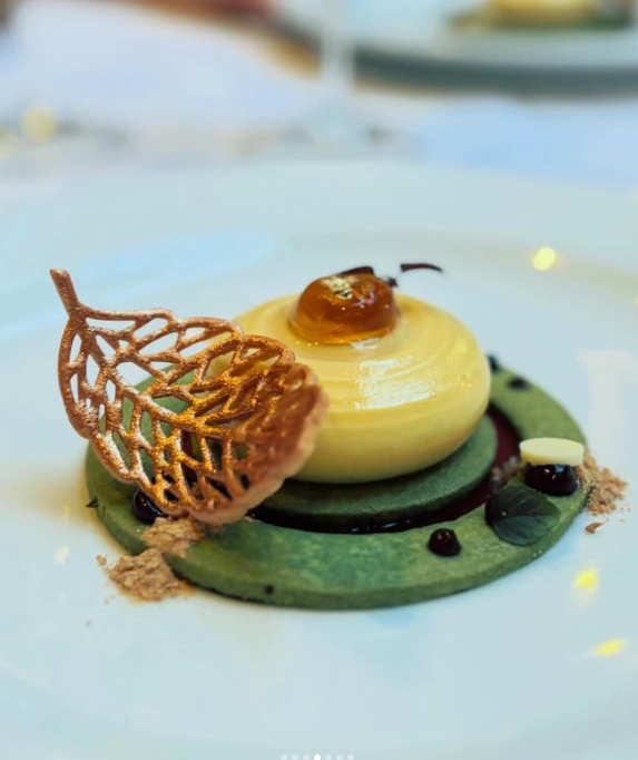 A sculptural dessert with a golden lattice and green base